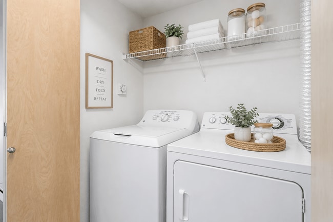 Convenient in-home laundry with added storage and stylish organization. - Villas at Lawrence