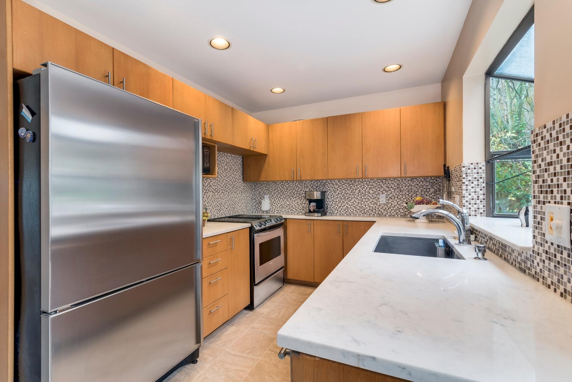 Kitchen with new counter top and a large refrigerator. - 1604 Lakeview Blvd E