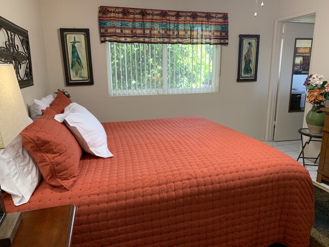 Master bedroom recently upgraded with a king-size bed and new bedding. - 10113 W Pebble Beach Dr