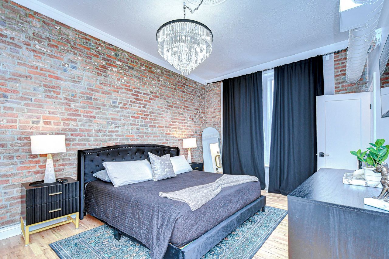 Large chandelier over the bed gives it an luxury feel - 215 Central Ave