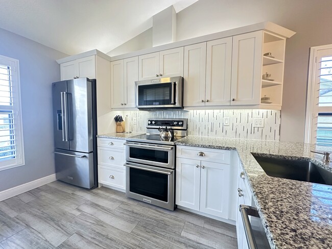 Kitchen and stainless appliances - 7723 SE Sugar Sand Cir