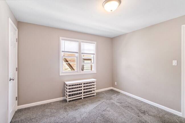 Building Photo - This spacious upper unit features 2 comfortable bedrooms with carpeting