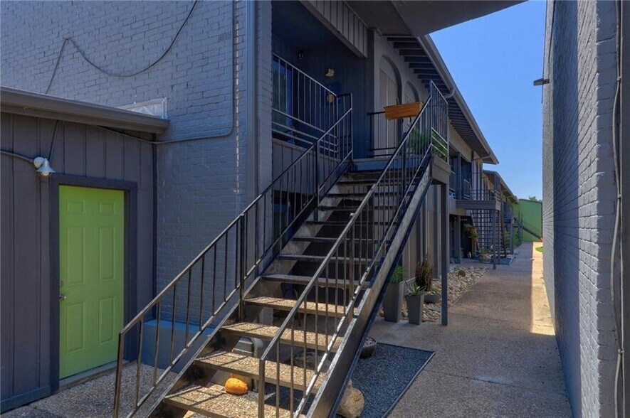 The apartment is located on the second story and features a shaded patio. - 909 Reinli St