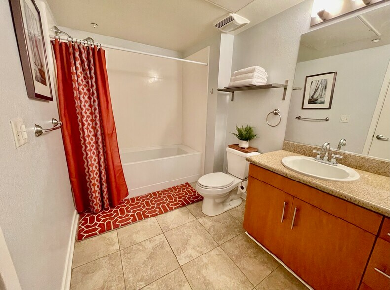 Clean & modern with tub/shower combo, granite vanity & plush towels. - 3687 4th Ave
