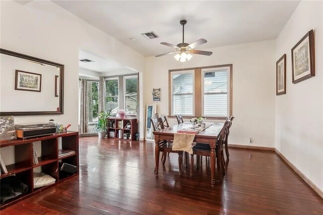 Large common living area features a large dining table, bay window - 5830 S Robertson St