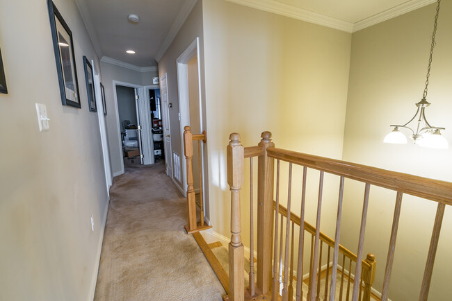 Upstairs hallway, laundry and storage on the right, master bedroom doorway is at the end of the hallway away from additional bedrooms for privacy. - 22785 Settlers Trail Terrace