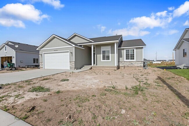 Building Photo - NEW HOME with large garage stalls and unfinished basement for additional storage
