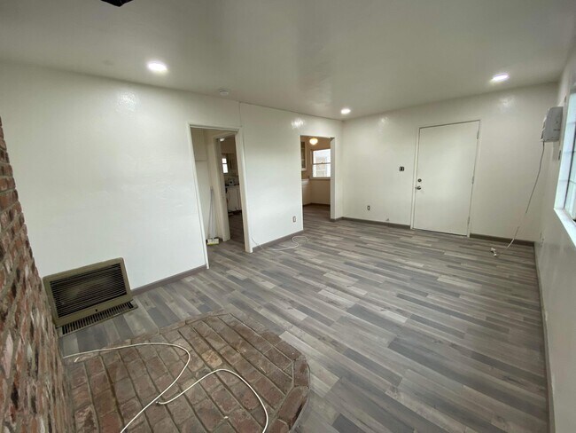 living room showing kitchen and front door - 33634 Colorado St