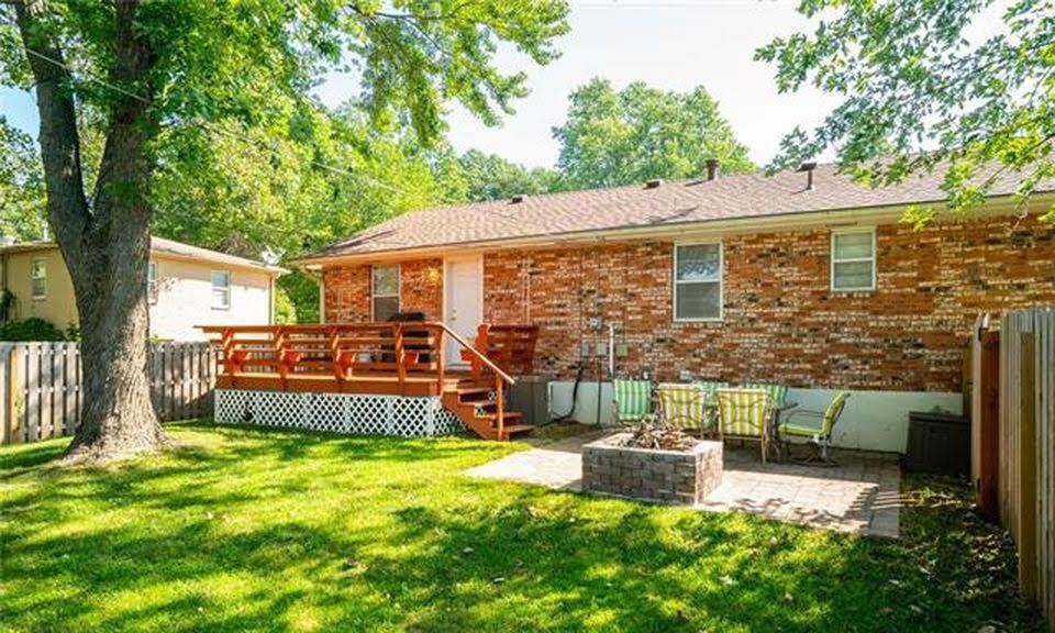 Serene backyard with hammock poles, paved patio, and deck with seating installed. Great for entertaining! Firepit great for fall nights! - 7416 N. Central St.