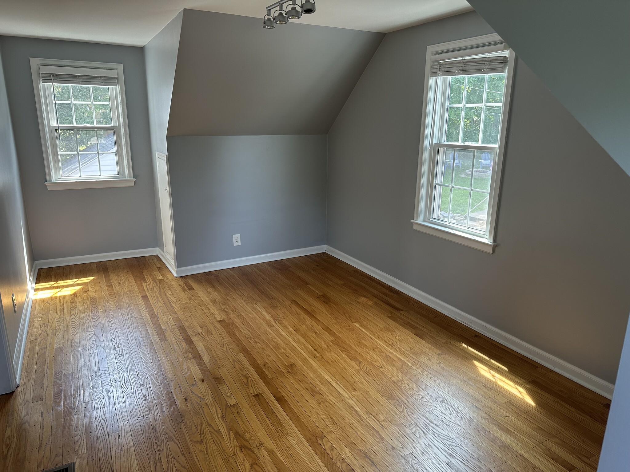 Third bedroom upstairs mirrors second bedroom with windows on three sides. - 5101 Boulevard Pl