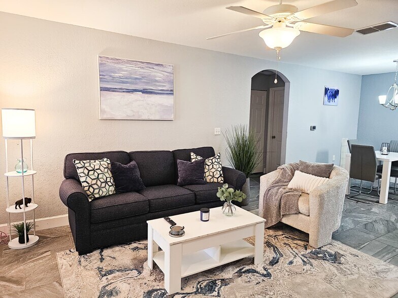 Enjoy plenty of seating for 4 people in the living room area with all the essentials - 8923 Manor Loop