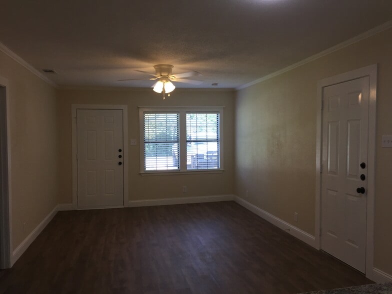 Living room with front and side exterior doors - 310 East 3rd St.