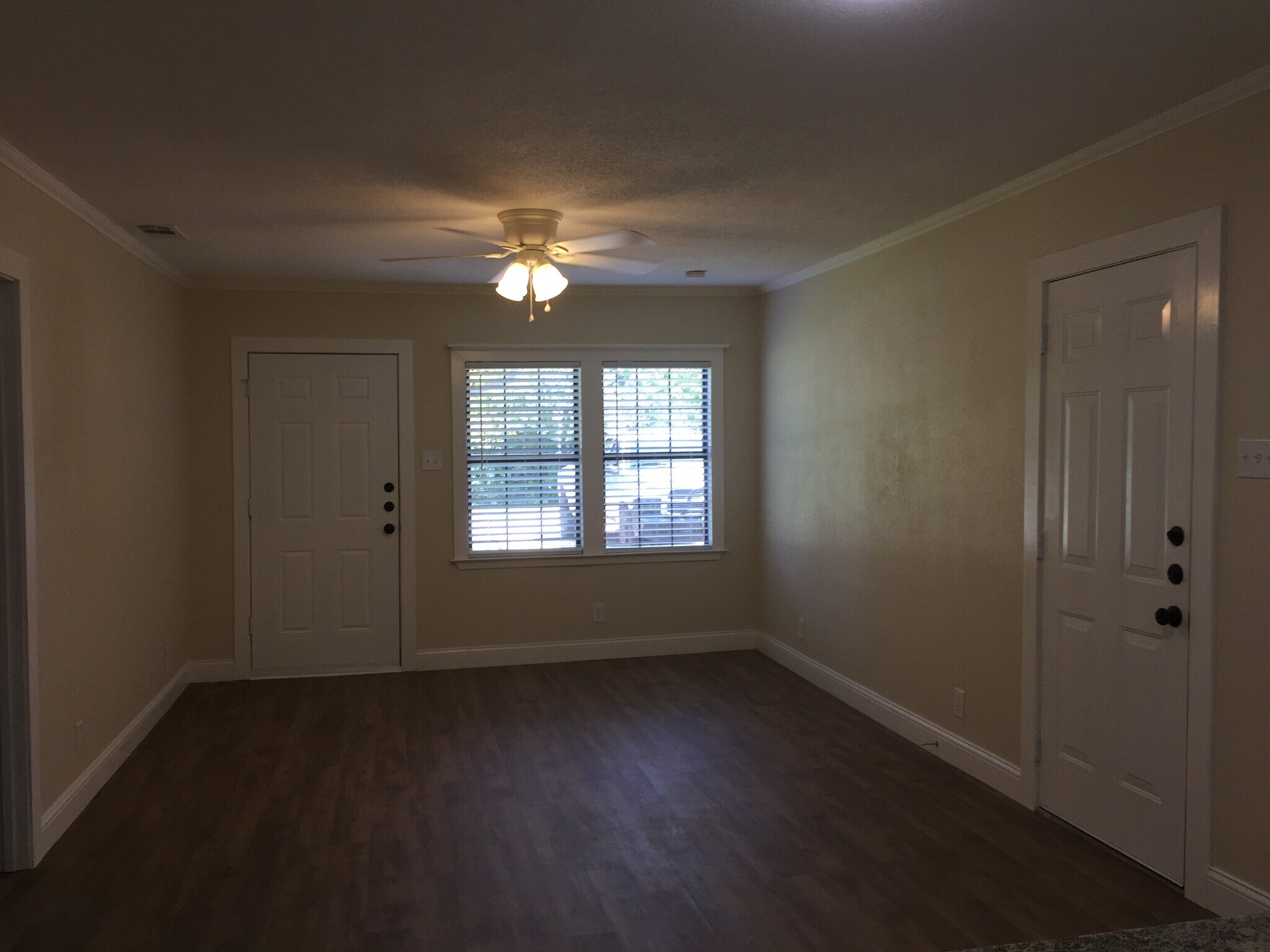Living room with front and side exterior doors - 310 East 3rd St.