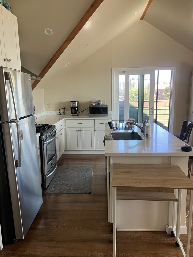 open kitchen that leads to a balcony - 404 Webster St