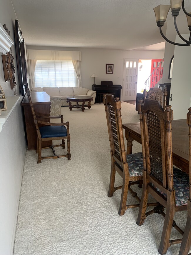 View of dining area to large living room and front entry - 8561 Windlass Dr