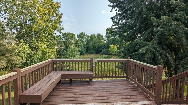 Dinig patio walks out to a deck with a built-in bench and stairs that lead to a stamped patio. - 758 Park Brook Rd NW