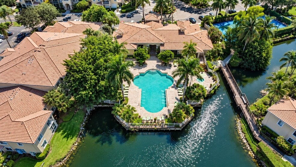 Immerse yourself in the serene beauty of Ibis Reserve, featuring a stunning pool surrounded by lush landscaping and tranquil waterways. This oasis is perfect for relaxation and socializing. Don’t miss the chance to make it your own! - Ibis Reserve Apartments