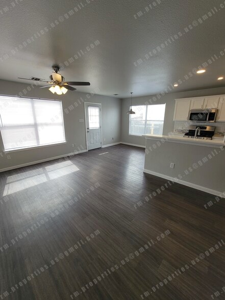Living room with new ceiling fan and new vinyl flooring - 2874 Southampton Way