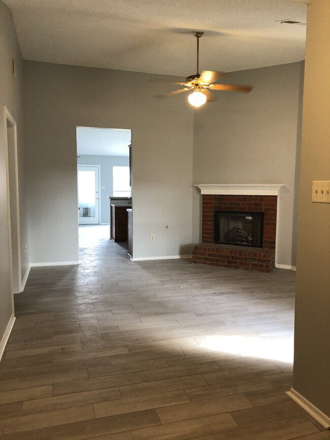 Living room with fireplace and tile floors - 5420 Payton Dr E