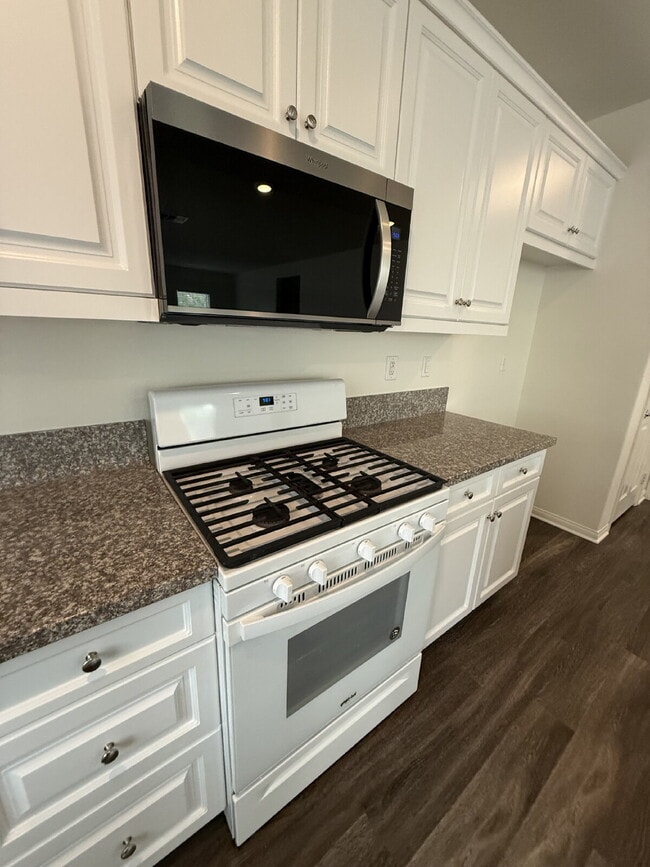 Building Photo - New flooring & paint!  Large backyard - landscaped and ready for garden!   Community pool, fitnes...