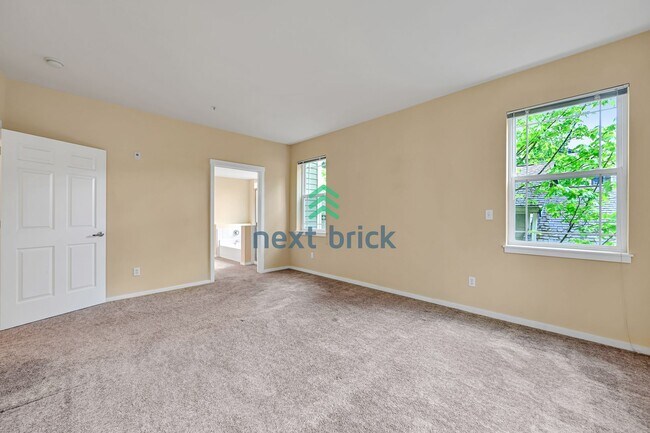 Building Photo - Rare Ground-Floor, End Unit with massive b...