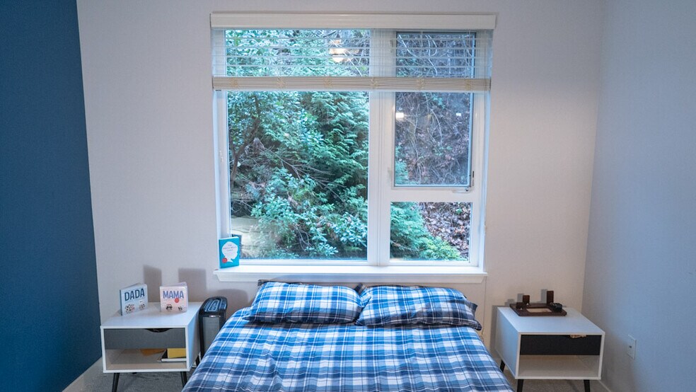 Large window that looks out towards green belt bustling with birds in summer. - 375 Kirkland Ave