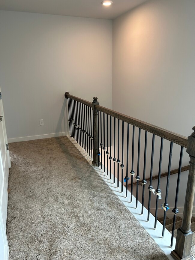 Hallway at the top of the stairs to the master. Laundry area on the left. - 226 River Meadow Dr