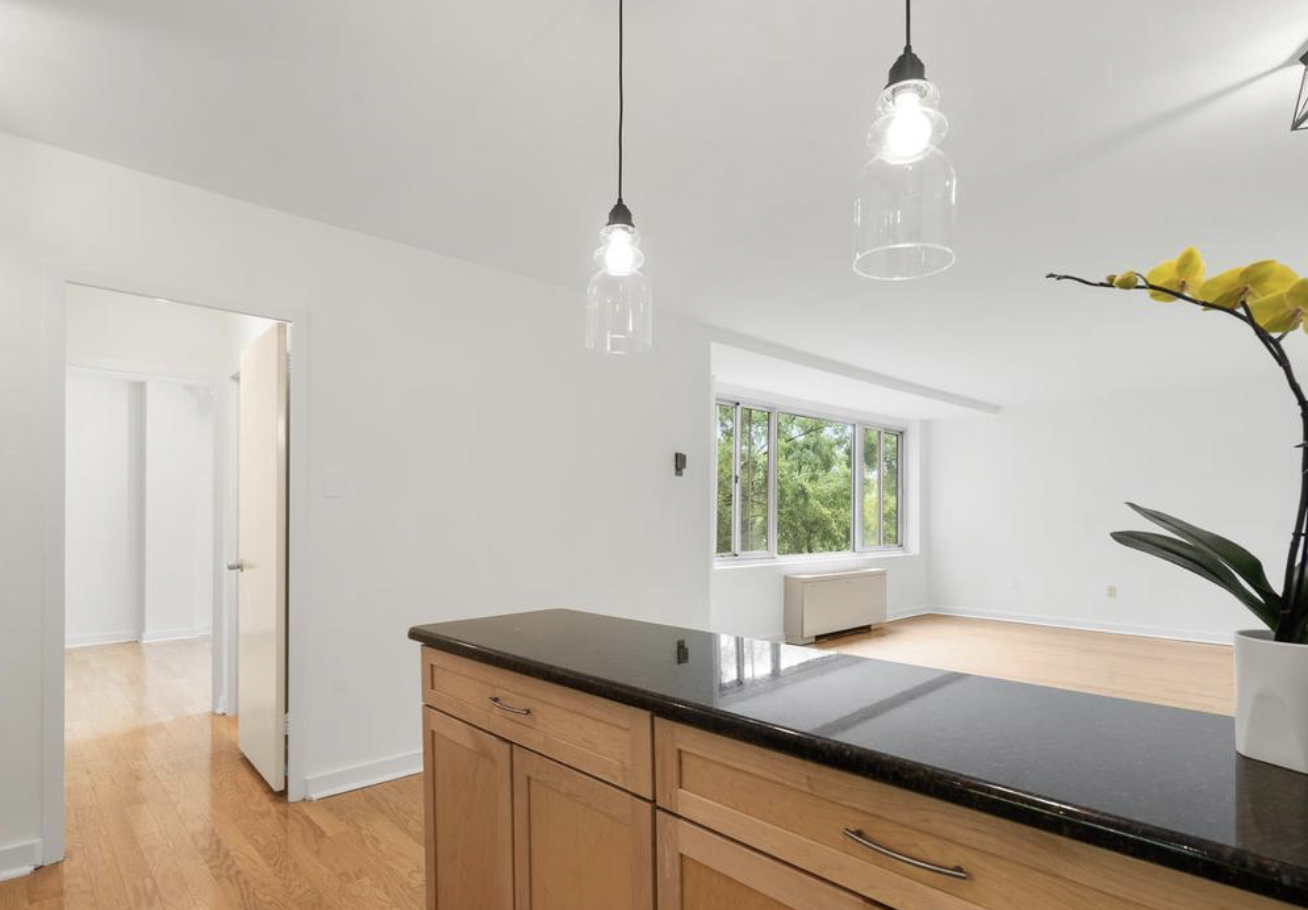 Updated Open Kitchen – Granite counters, breakfast bar, and ample storage. - 4000 Tunlaw Rd NW