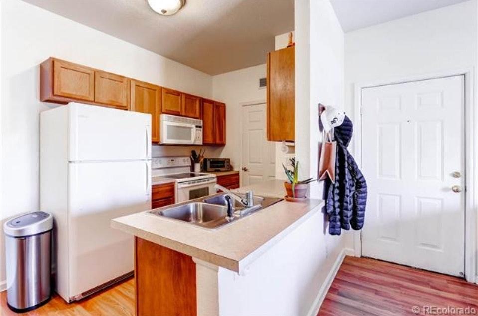 Kitchen with pantry, garage disposal, and dishwasher - 5633 E Atlantic Pl