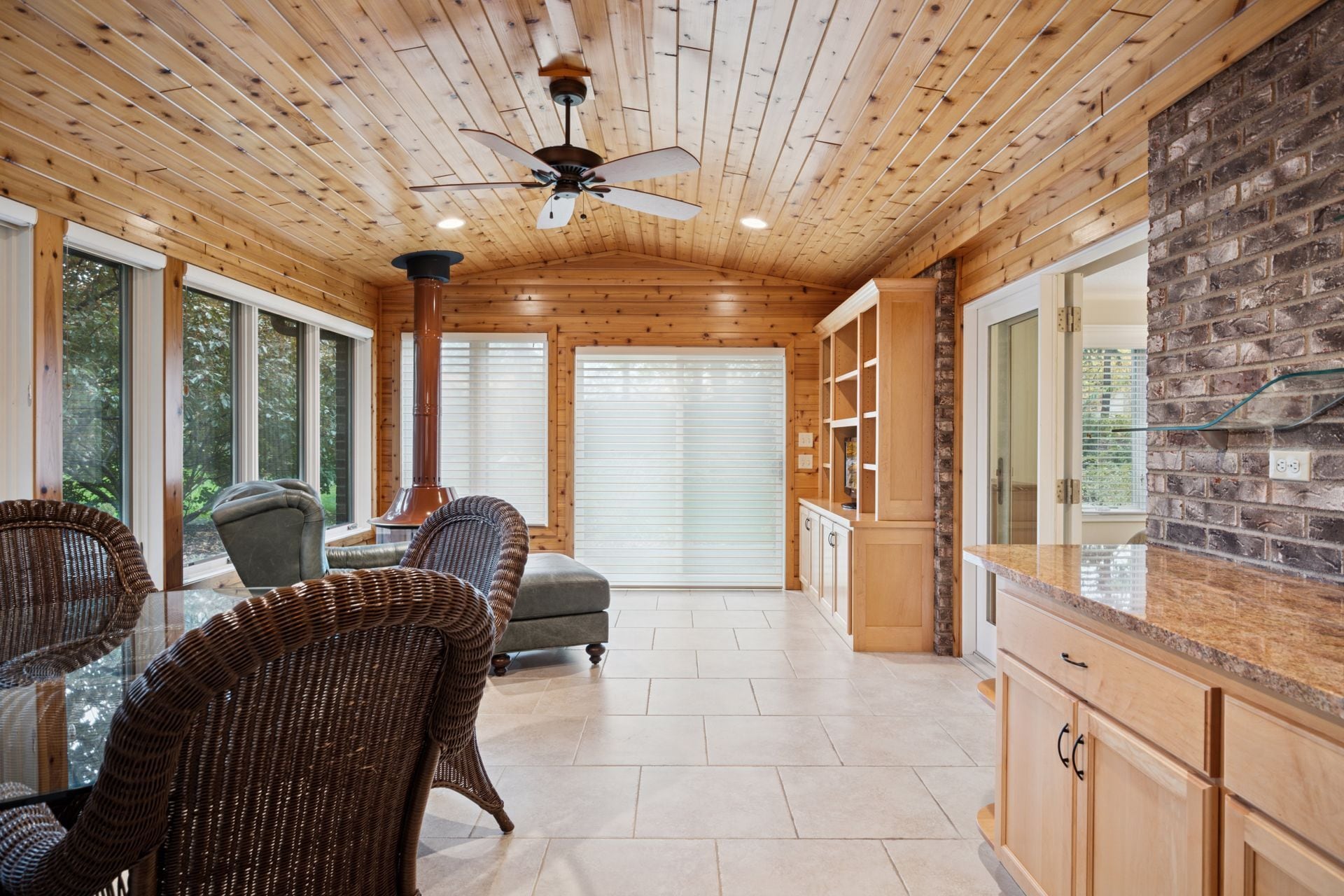 Fabulous year-round sun room features gas fireplace and pine tongue and groove ceiling/walls. - 145 Holly Ln N