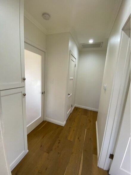 Hallway off of the living room can be closed off. Leads to closet space, bathroom, and 2 bedrooms - 1733 Phillips Way