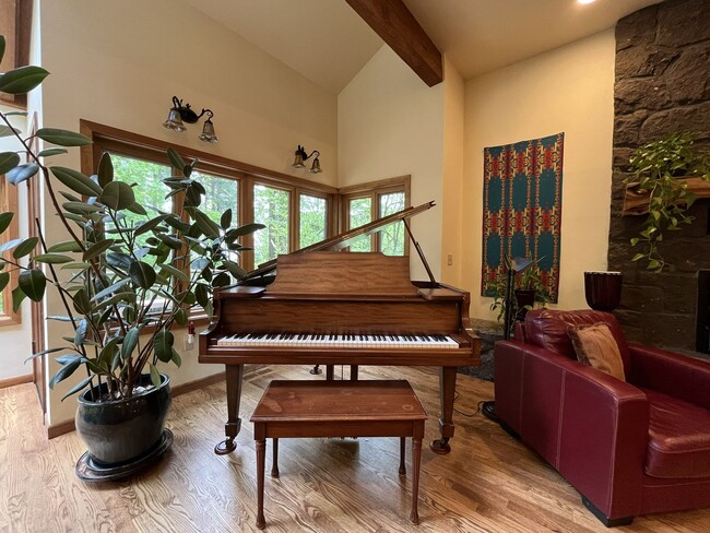 Building Photo - One-of-a-Kind Custom Home with Wall of Windows, Stone Fireplaces, Expansive Entertainment Space &...