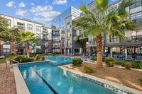 Resort-Inspired Pool with Sun Ledge, Lap Pool, and Waterfall - The Atlantic Memorial