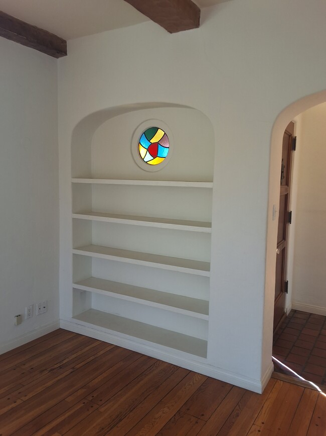 Living Room bookshelf/stained glass - 5251 W 9th St