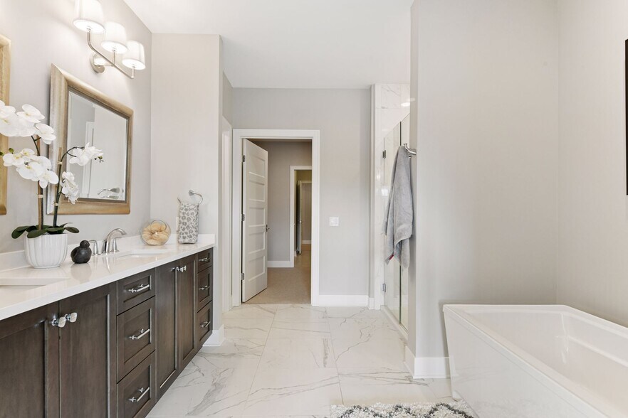 Primary bath with double sinks, heated floors, large soaker tub, and walk-in shower - 222 Ferndale Rd S