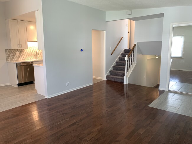 View from livingroom into kitchen/dining room + upstairs to bedrooms and full bath - 367 Ashwood Ct