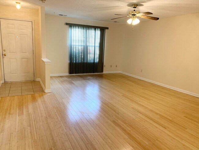 Front entry, half bath to the left, and living room - 7985 Marsha Woods Dr