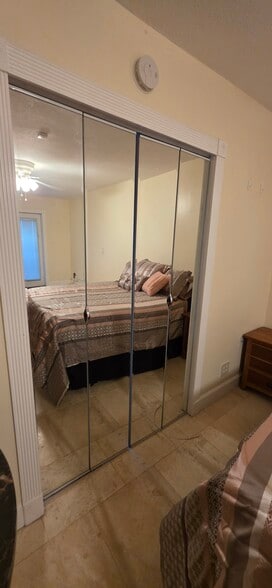 Mirrored doors to large walk-in closet/kitchenette area - 10910 Diego Dr N