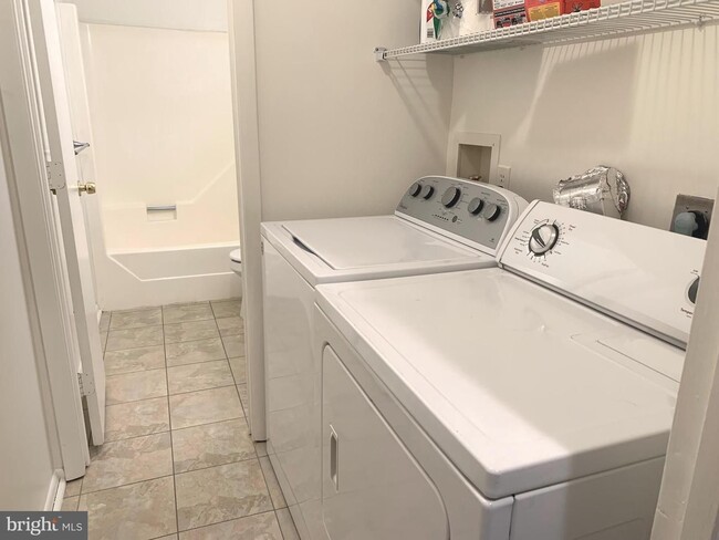 Building Photo - Beautifully updated 2 bd 1 bth patio level condo backing to open area.