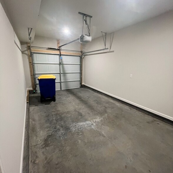 Private attached garage with room for parking and storage—a bonus for convenience and security - 205 Cherry Way
