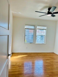 Comfortable bedroom with mirrored closet doors, generous storage space, windows, and remote-control - 3551 W Manchester Blvd