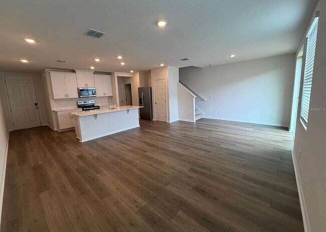 Building Photo - "Spacious 3-Bedroom Townhouse with Granite Elegance in St. Cloud – 4543 Rangeland Way"