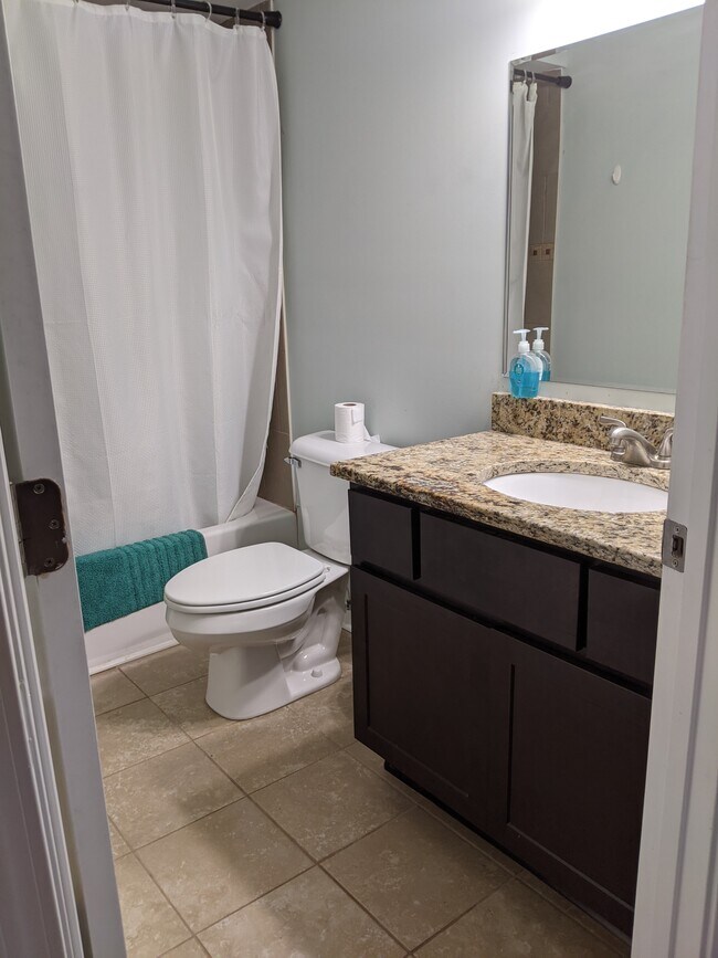 The first full bathroom with tub. - 2414 Lake Park Rd