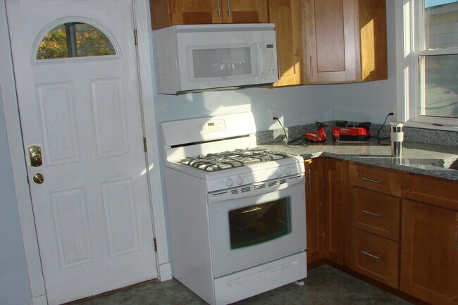 View of stove, microwave and cabinets - 713 Orchard St