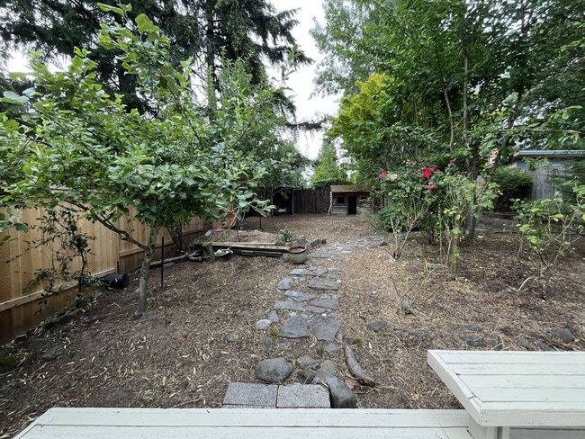 Building Photo - Spacious 3-Bedroom Home with Custom Stone Fireplace, Attached 2-Car Garage & Expansive Backyard i...