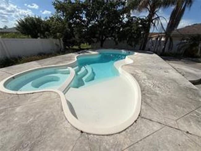 Building Photo - Charming 3-bed, 2-bath POOL home with 2-car garage. Features ceramic tile flooring, updated kitch...