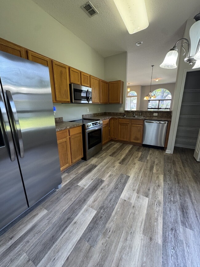 Building Photo - Spacious 4 Bedroom Pond-View Home with Upg...