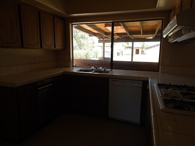 Building Photo - This property is a 3 bedroom, 2 bathroom home featuring an open floor plan with tile throughout. ...