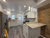 Building Photo - 3 Bedroom End Unit with Finished Basement and Fenced Yard on E 28th Street