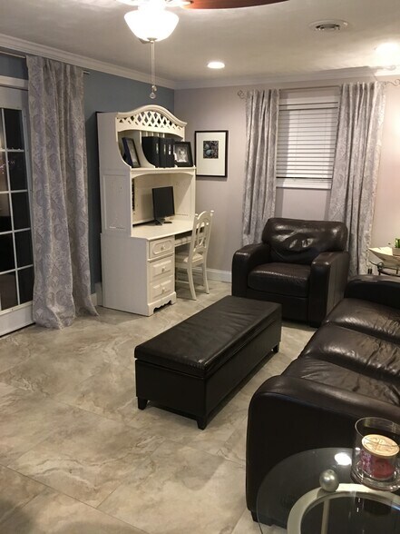 Living room with French doors that open to stamped concrete patio. 24x24 Porcelain tiles and In floor heating throughout. - 924 Byford Boulevard